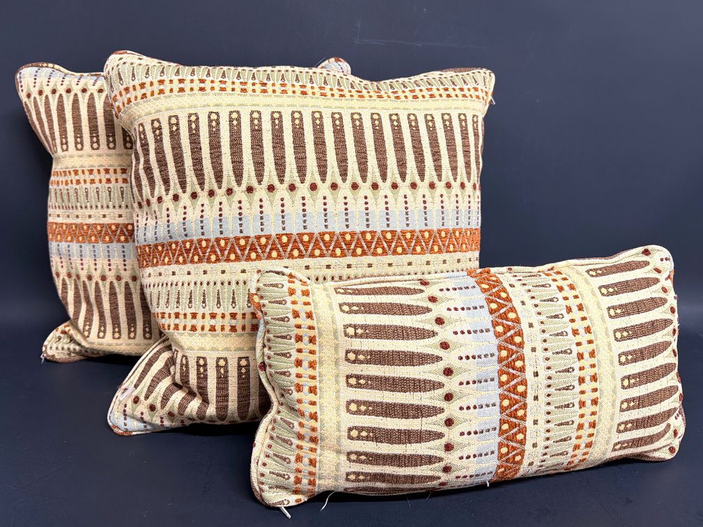 Throw pillows in blue, rust, brown