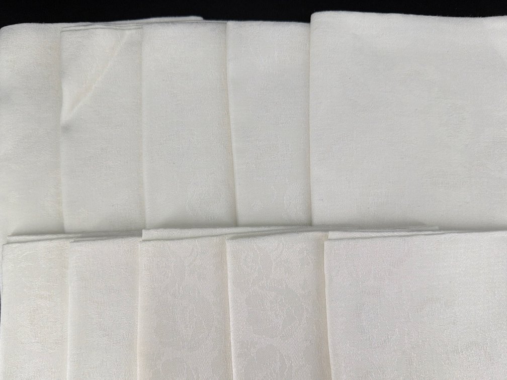 Ten white damask napkins