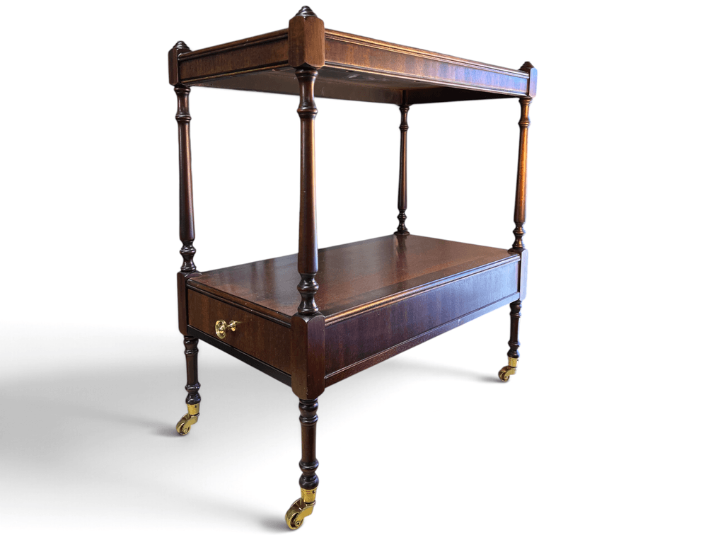 Slender mahogany Sheraton style end table with casters