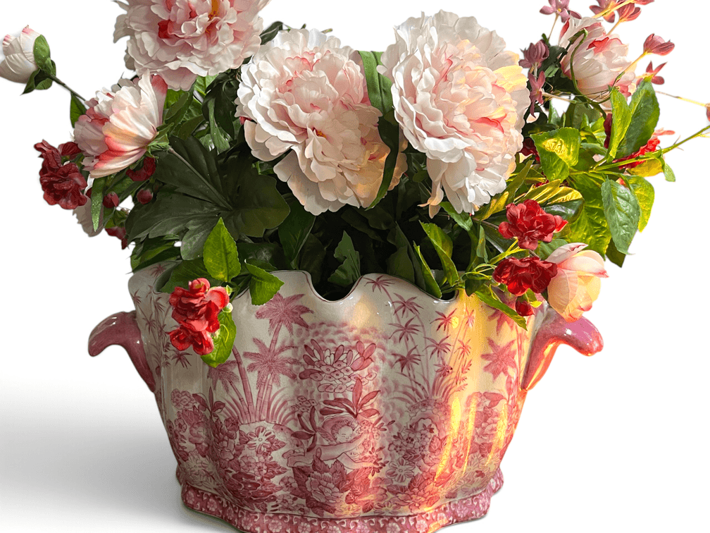 Pink and white jardinière with artificial floral arrangement
