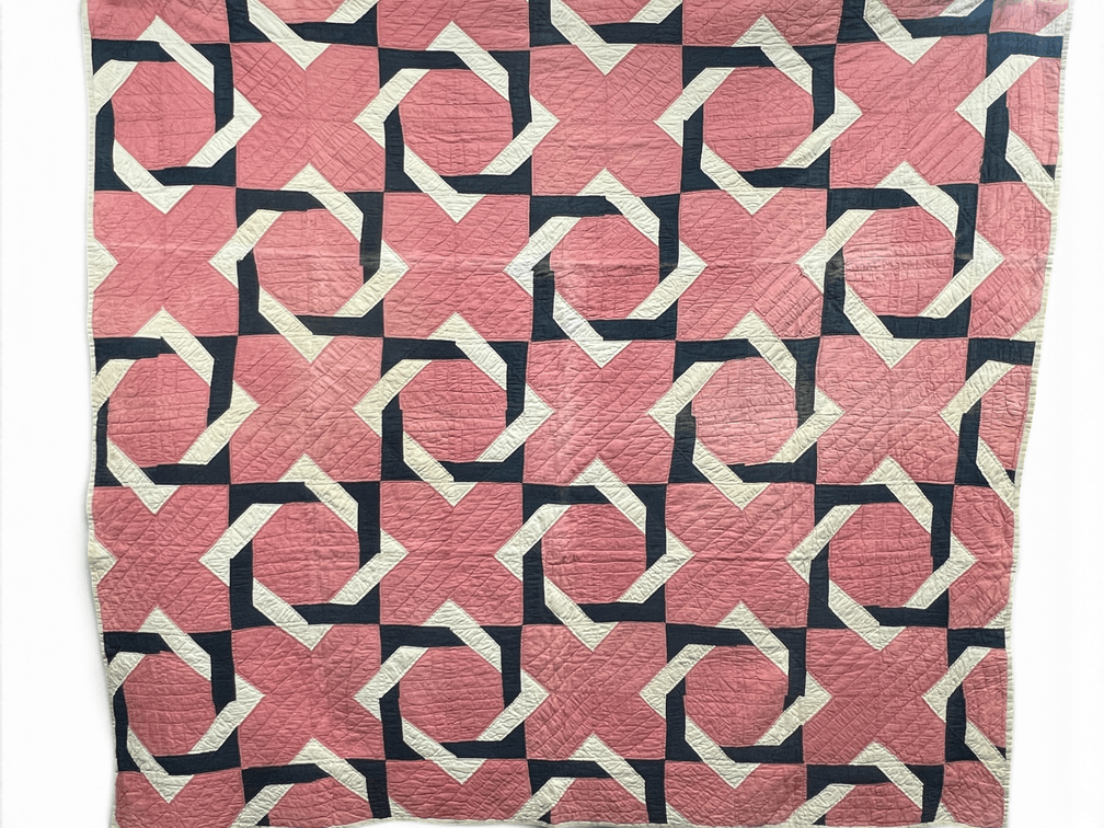 Vintage cotton quilt in the Carpenter's Wheel or Steeplechase pattern in pink, white and navy