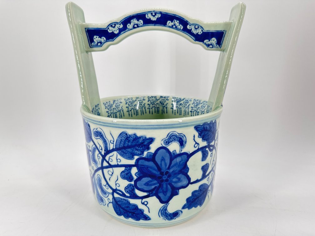 Decorative blue and white canister with handle