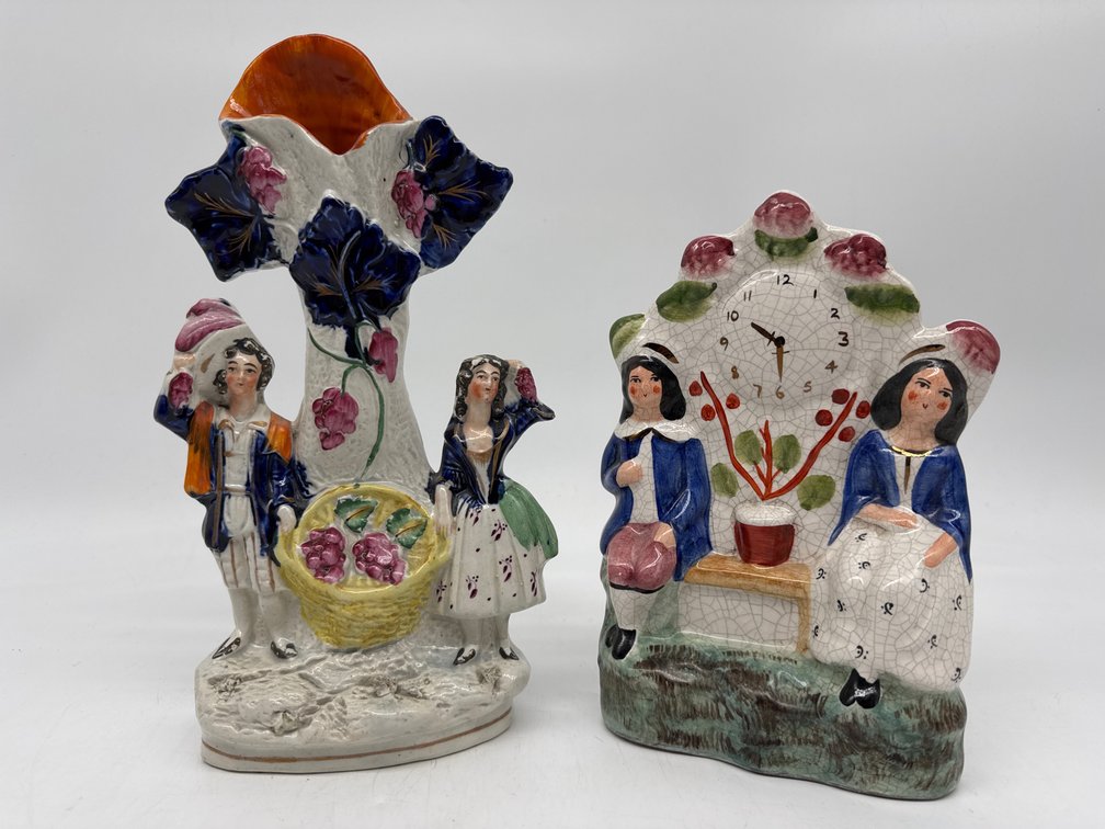 Two antique figural Staffordshire spill vases and clock tower