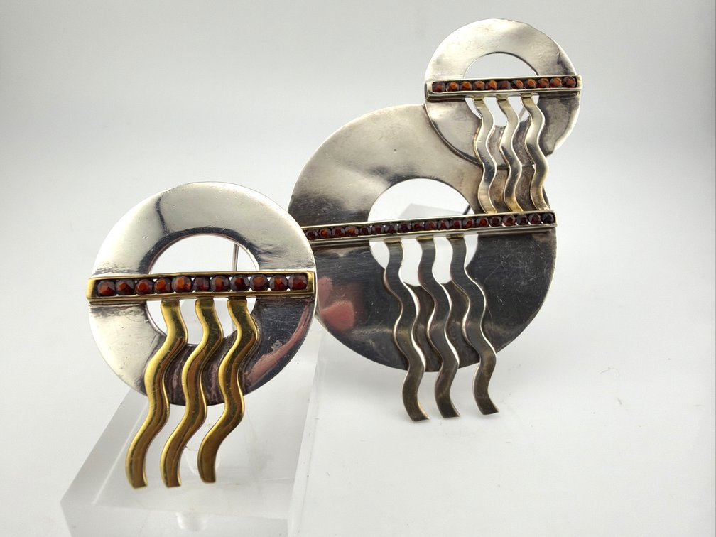 Two signed Jing sterling and garnet Modernist brooches
