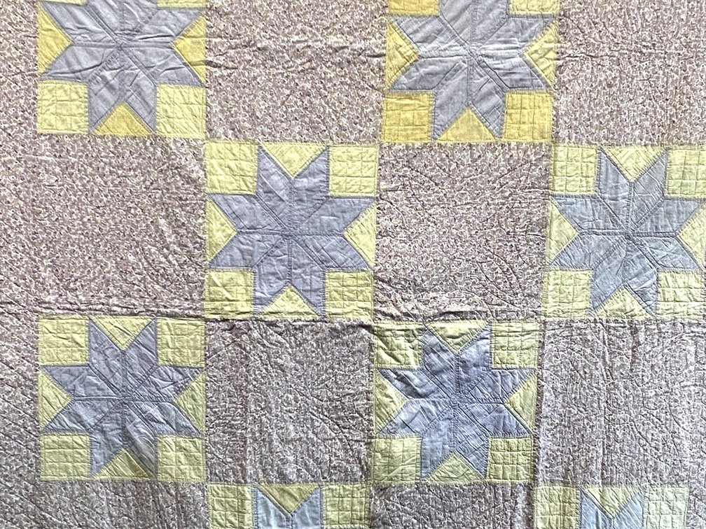 Patchwork 8 point star block quilt in yellow and lavender floral prints