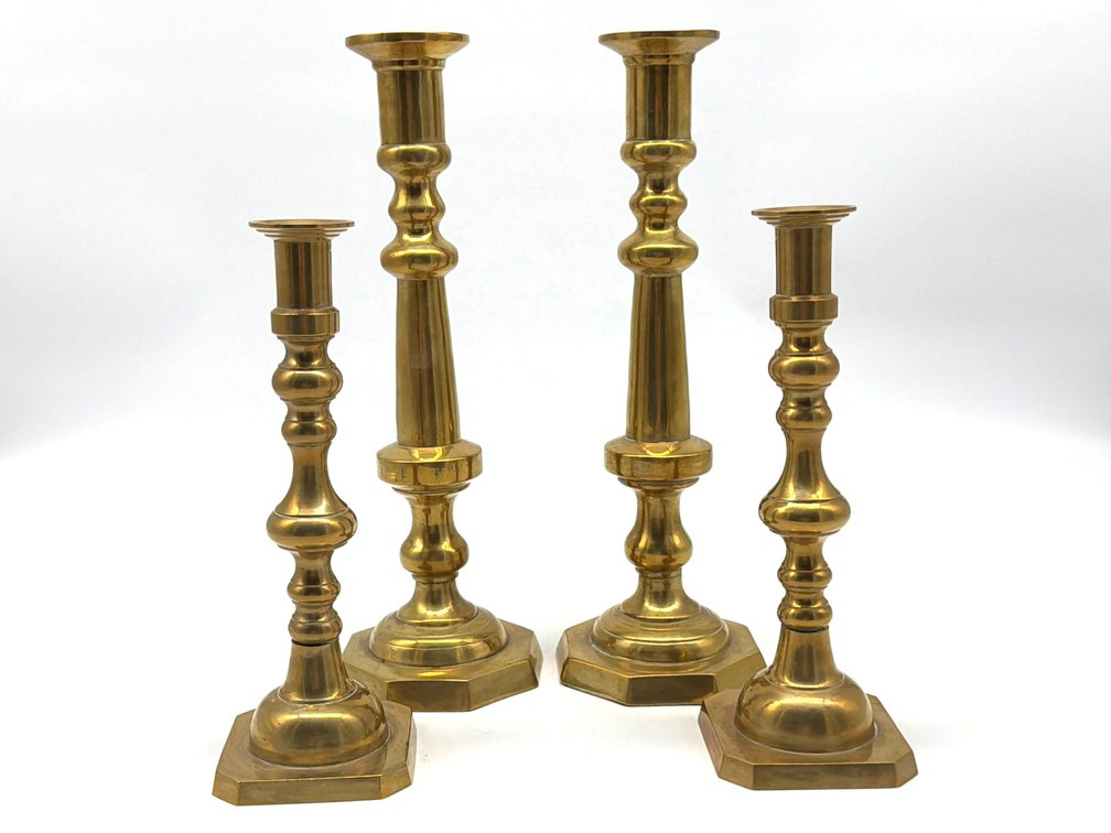 Two sets of brass candlesticks