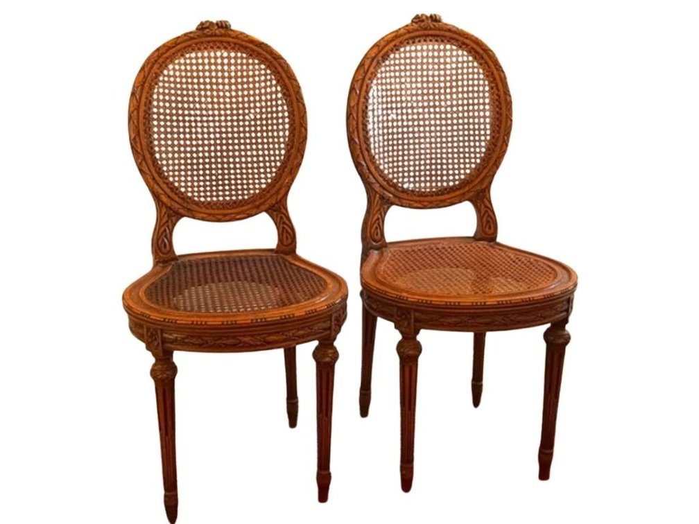 Pair of Louis XVI style walnut cane chairs; HALL 