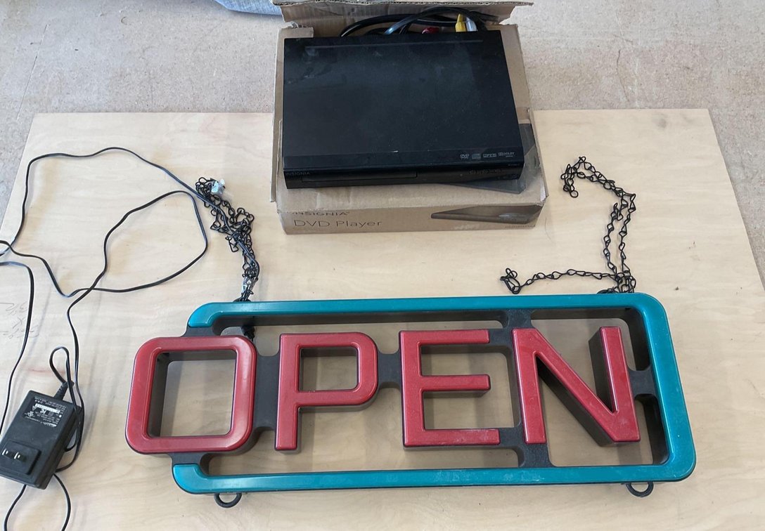 "Open" Neon Sign and DVD Player