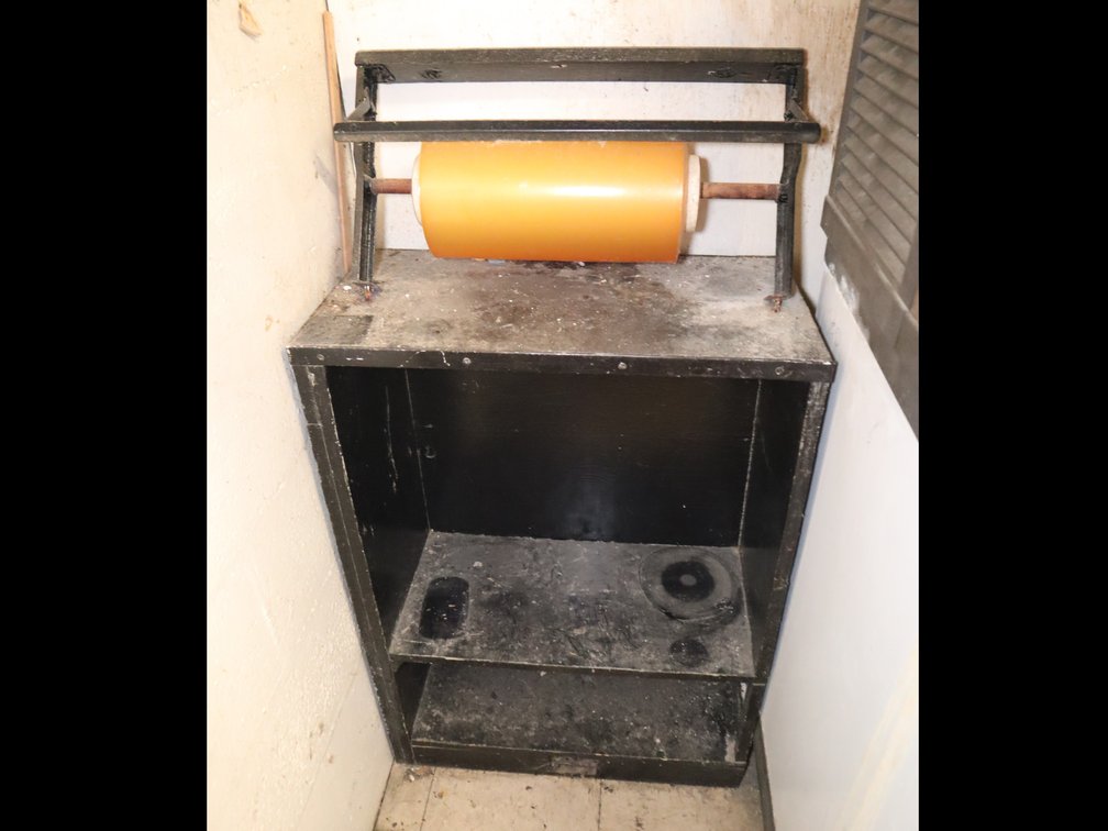 Roll of Shrinkwrap & Wooden Shelving Unit with Metal Rim Band