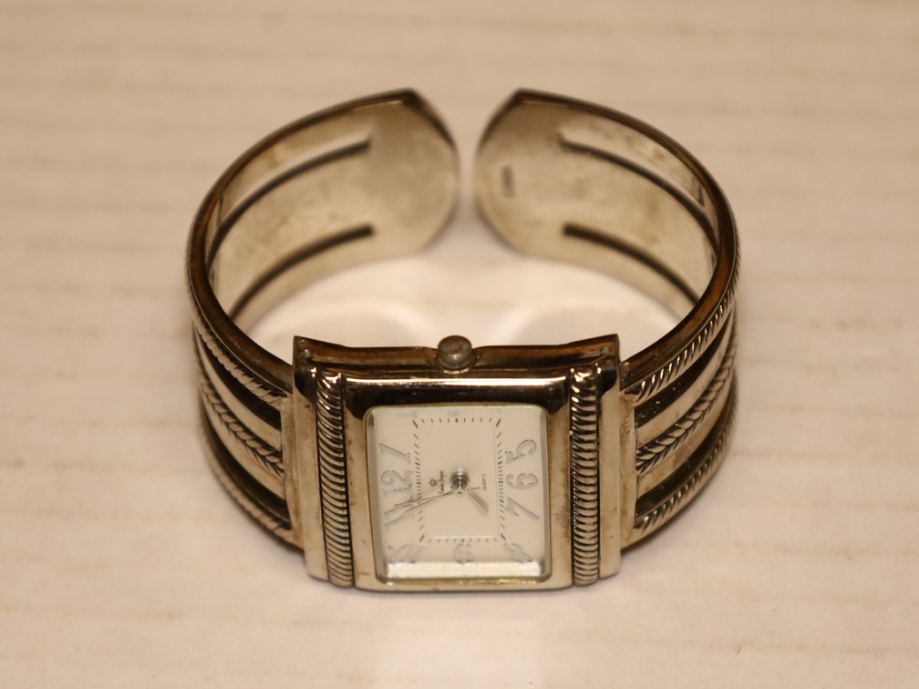 Willow Tree "Angel of the Garden” figurine, square-face cuff watch, strands of natural seed and shell beads.