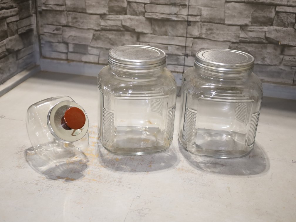 (2) Large Glass Storage Jars w/ Metal Lids & Small Glass Jar w/ Knob Lid
