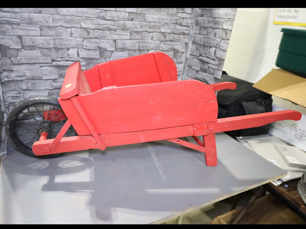 Decorative red wooden wheelbarrow