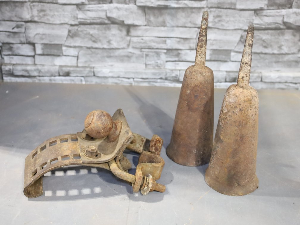 Vintage adjustable clamp-on trailer hitch and metal cemetery flower vases