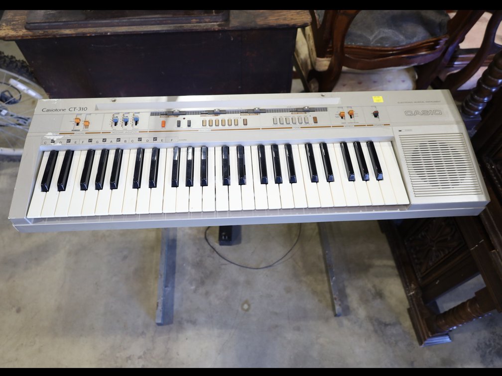 Casio electric keyboard on stand