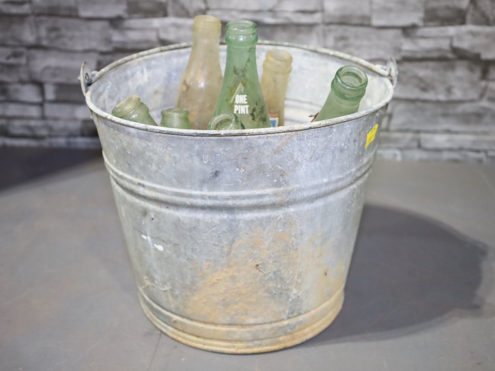 Galvanized bucket and 7 vintage glass soda bottles