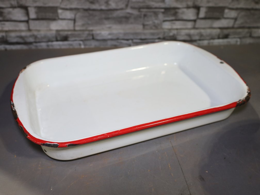 Red-trimmed white enamel baking pan, speckled enamel spaghetti strainer, and more