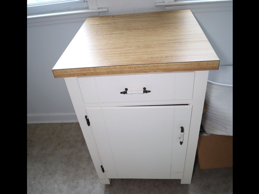 Rolling wooden cabinet with formica top