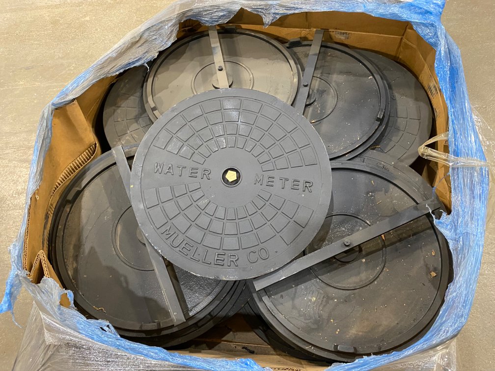 A Group of Mueller Co. Water Meter Covers