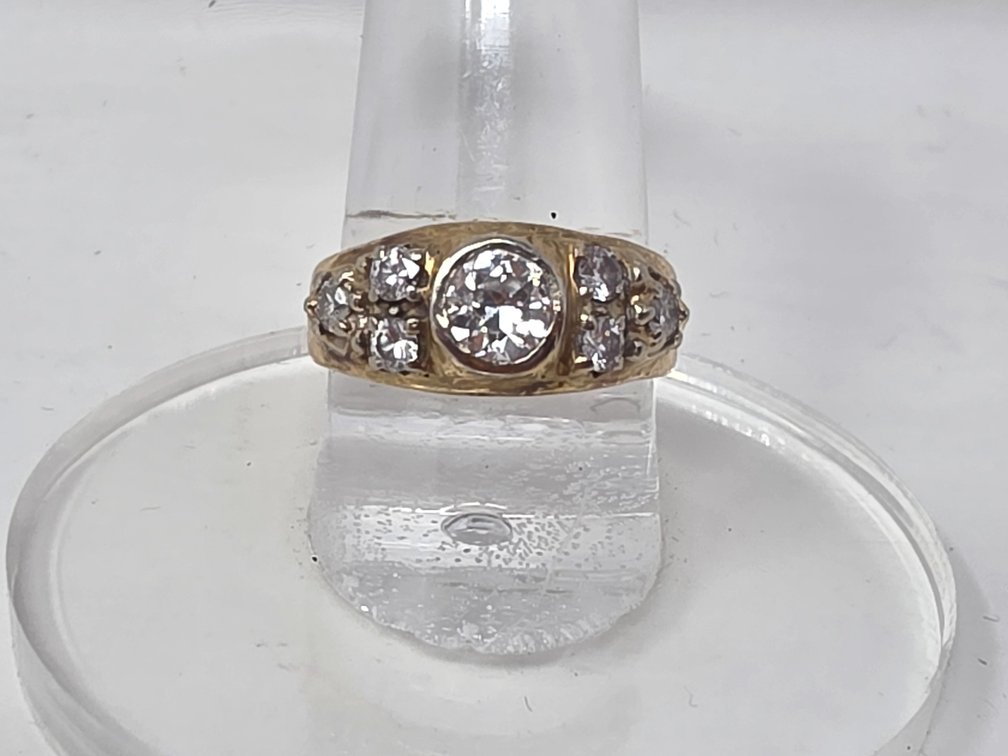 14-KT Bezel Set Diamond w/ Three Diamonds on Each Side - Size 7.5 - Center Diamond is .74 Carats Clarity: SI-2 Color H - .52 Carats - Side Diamonds Clarity: SI-2 - I-1 Color: H-I - 6.3 Grams Total Weight
