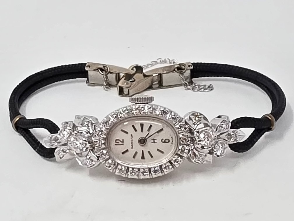 Hamilton 14-KT White Gold w/ Diamonds Lady's Watch w/ Cord Band - Round Single Cut & (4) Larger Round Brilliant Cut Diamonds .007 to .14 Carats Each (32 Total) .75 +/- Carats Total - Clarity SI-1 to SI-2 - Color: H-I - 12.5 Grams Total Weight