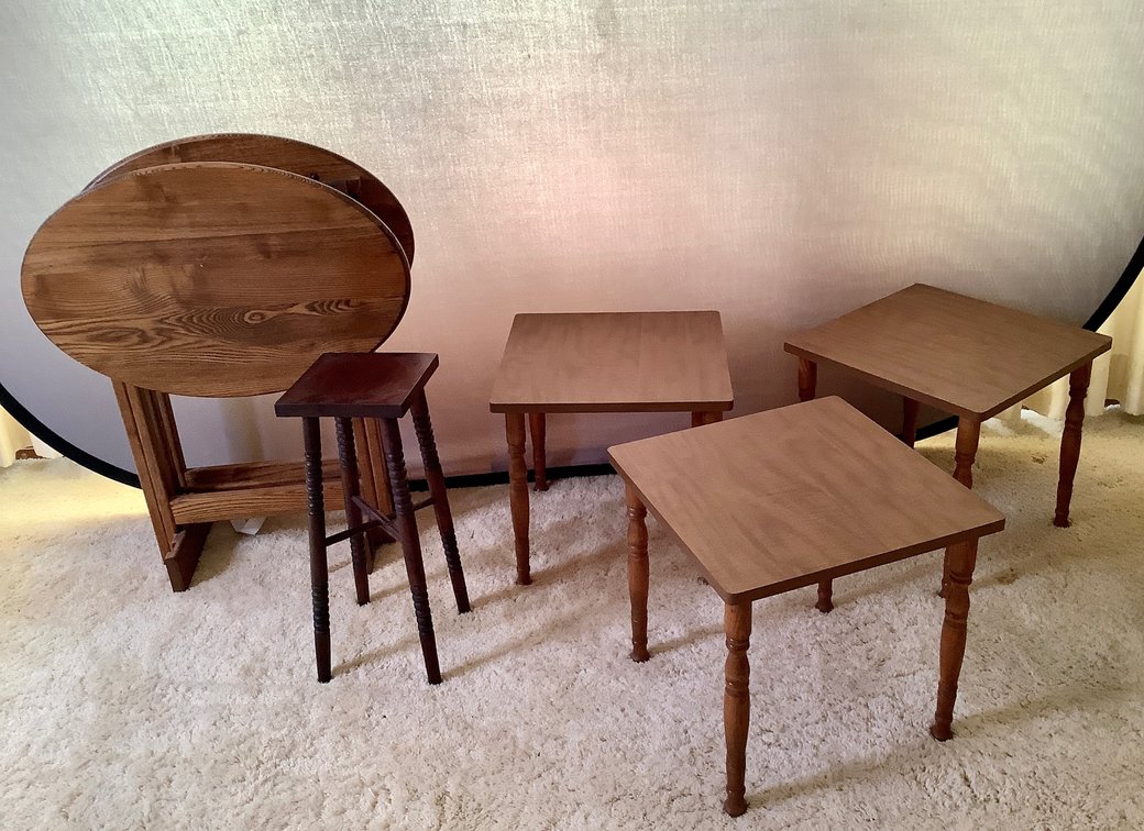 Wood TV trays and small nesting tables.