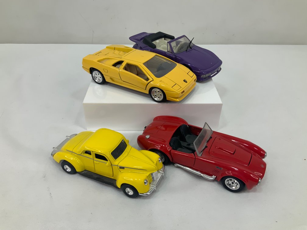 Four Die-Cast Model Cars Including Coupes and Convertibles
