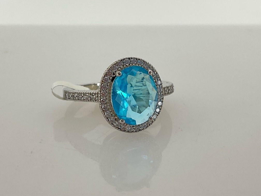 Sterling Silver Halo Ring with Light Blue Stone