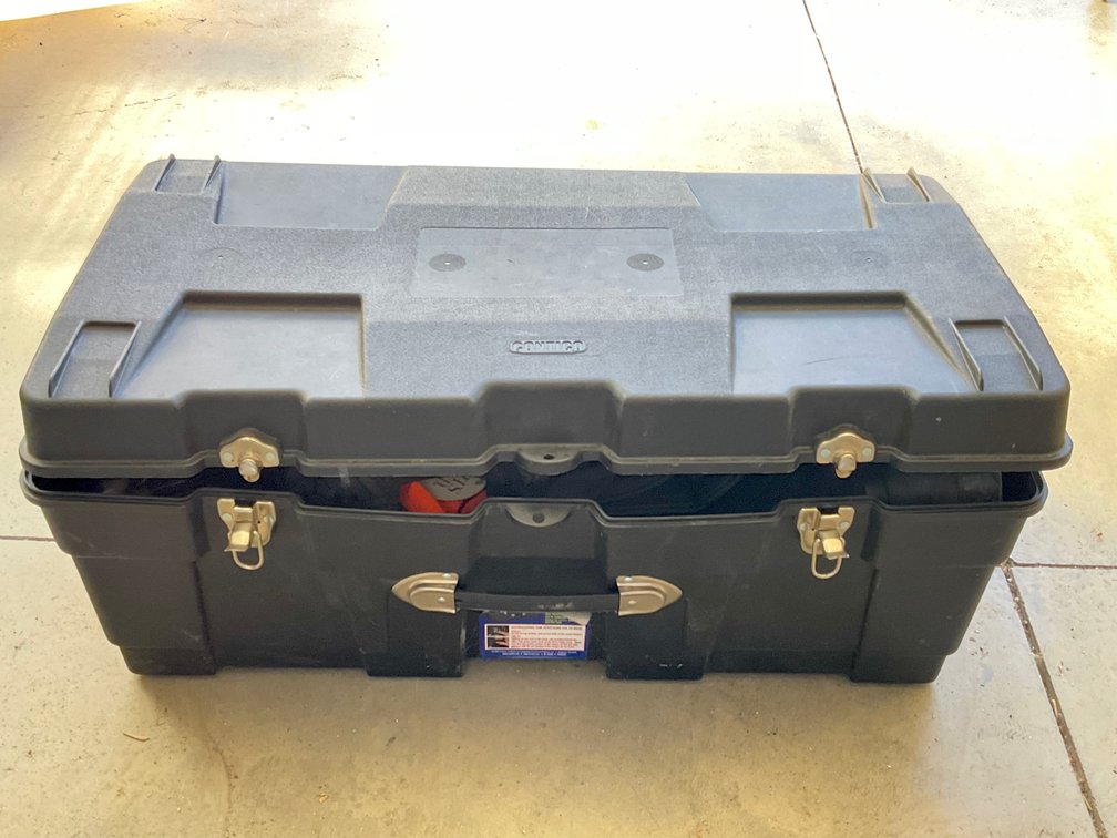 Storage Trunk with Boots, Hunting Apparel, and Camping Gear