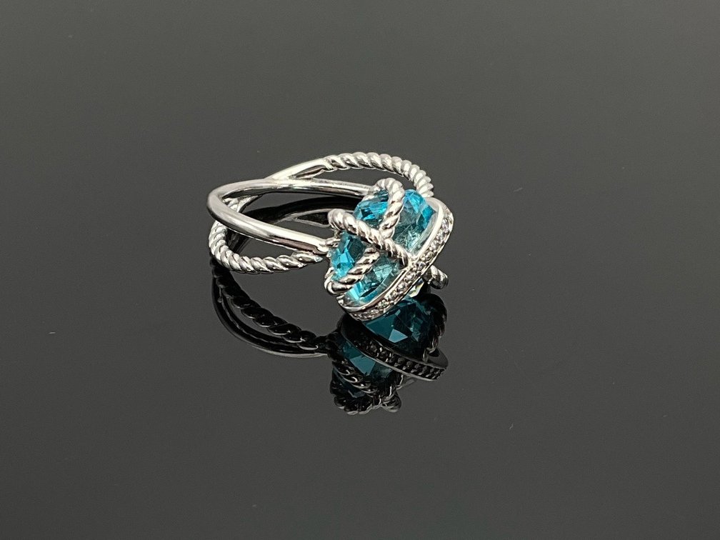 Silver Cable Crossover Ring with Blue Gemstone