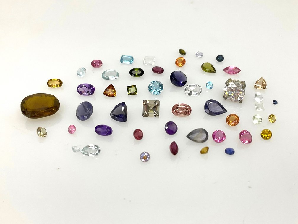 Loose Faceted Gemstones and Prong-Set Clear Stone