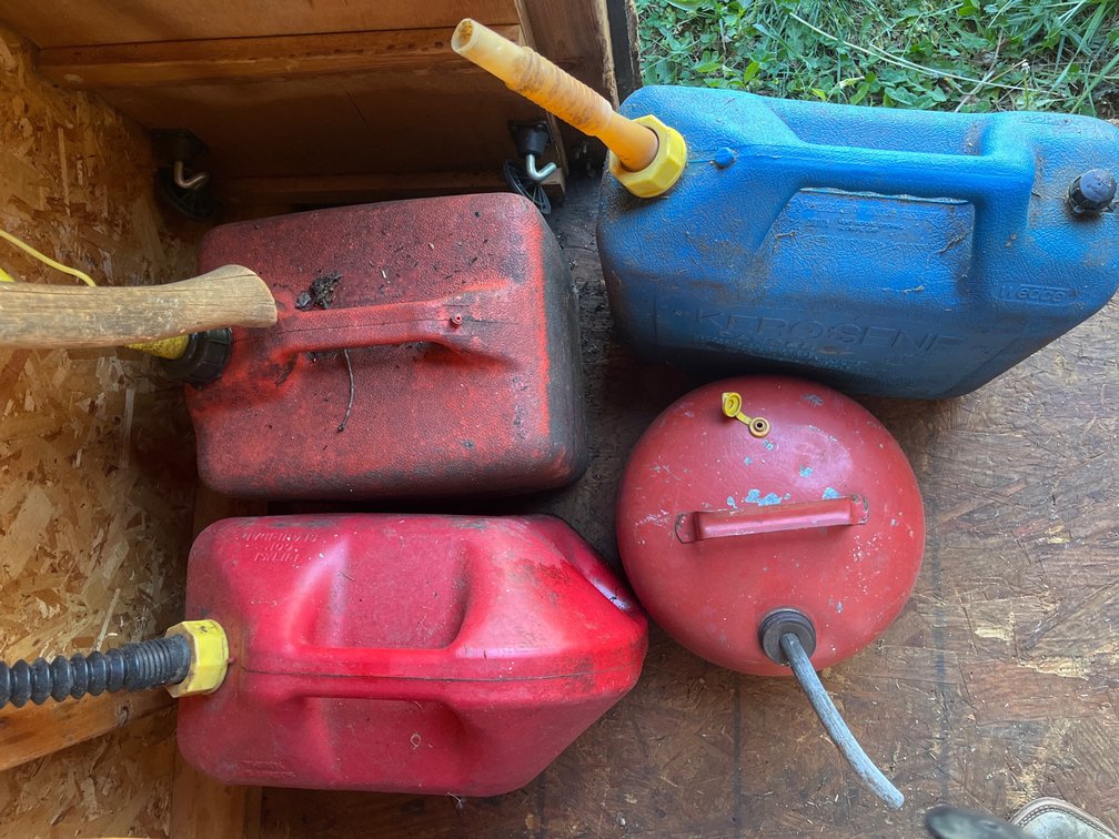 Three various gasoline cans & one Kerosene can