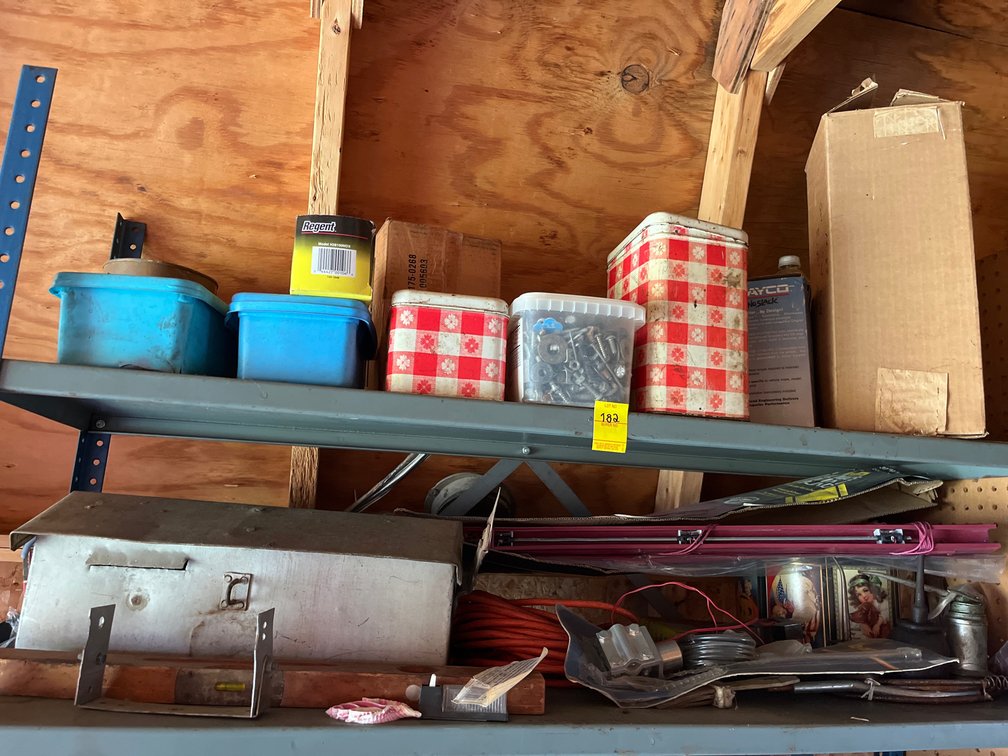 Two shelf lot of miscellaneous items including vintage tin, tool box, orange extension chord, various screws/bolts, & more