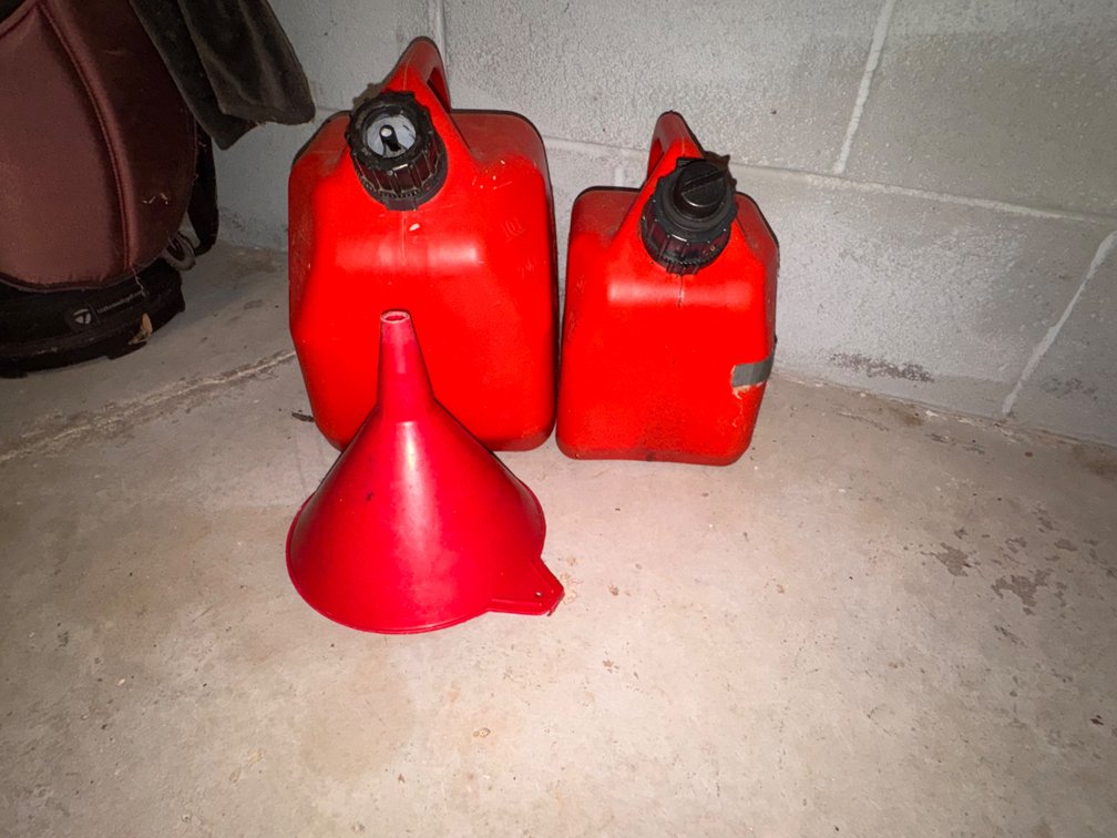 Lot of 2 Gas Cans With Gas in them & Funnels