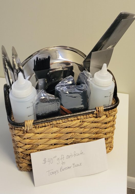 Blackstone 22-piece Cooking Tool Kit Basket includes long spatula, medium spatula, long fork, two tongs, scrapper, basting brush, basting cover, two squirt bottles, scouring pad handle with 10 replacement pads, apron, and $40 Tony’s Butcher Block Gift Cer