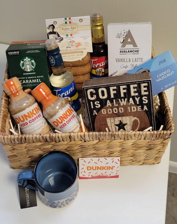 Coffee Basket includes box of Keurig caramel coffee k-cups, bag of vanilla latte coffee, French vanilla iced coffee, caramel iced coffee, vanilla zero-sugar syrup, salted caramel syrup, bag of milk and coffee cookies, box of choco hazelnut cookies, coffee