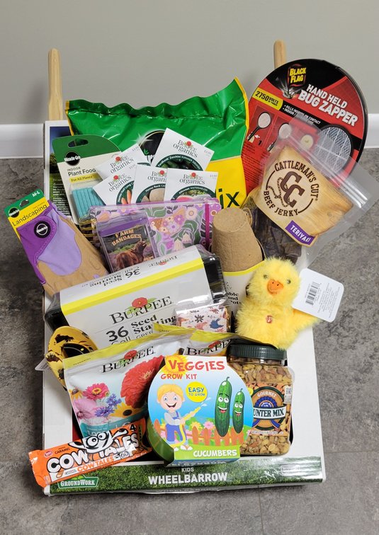 Gardening Items including bag of potting mix, plant food spikes, plantable fiber pots, seed packets (carrots, green beans, zucchini squash, cantaloupe, and watermelon), seed starting greenhouse kit, veggies growing kit, cutting wildflower mix, fast-bloomi