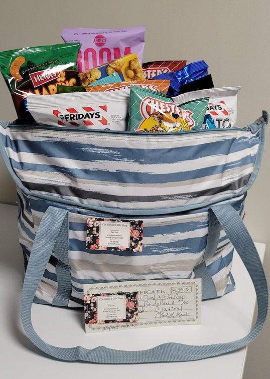 Snack tote bag includes popcorn, kettle corn, cheese curls, flavored fries, potato skins, various flavored pistachios, rice krispies treat, oreo cookies, and $25 CJ Floral & Gift Shop Gift Certificate; Donated by CJ Floral & Gift Shop