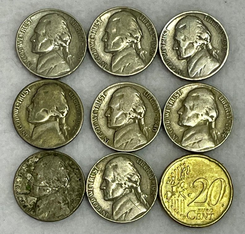 8 Nickels and a 2002 Euro 20 Cent Coin