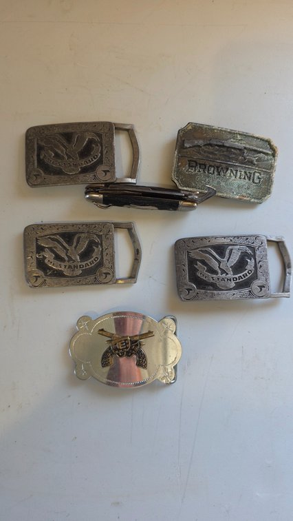 Five belt buckles, knife, and watch