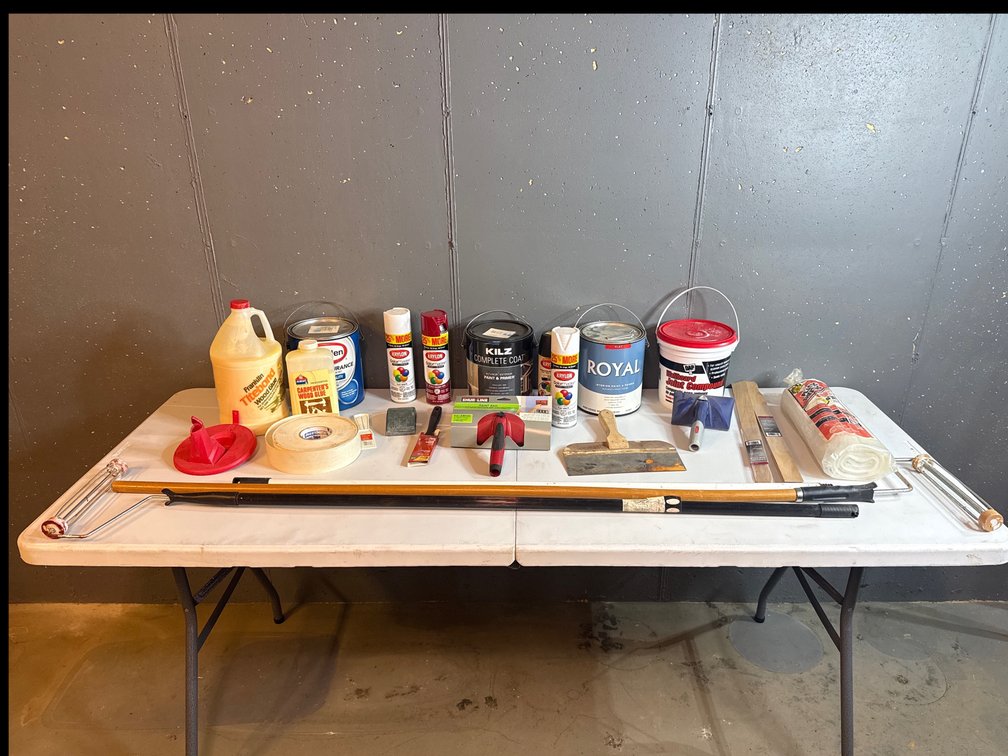 Assortment of paint and wood supplies