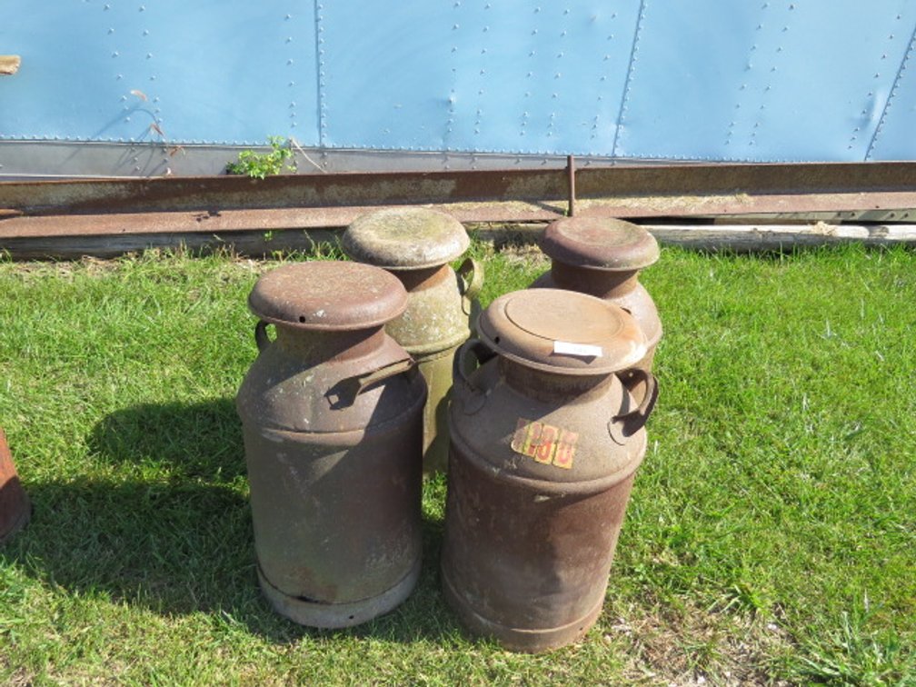Collection of antique metal milk jugs