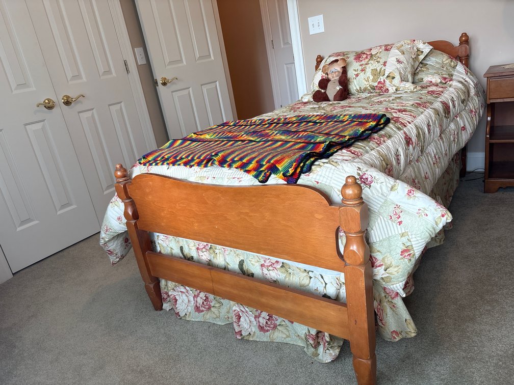 Wooden Twin Bed Frame with Bedding and Plush Toys