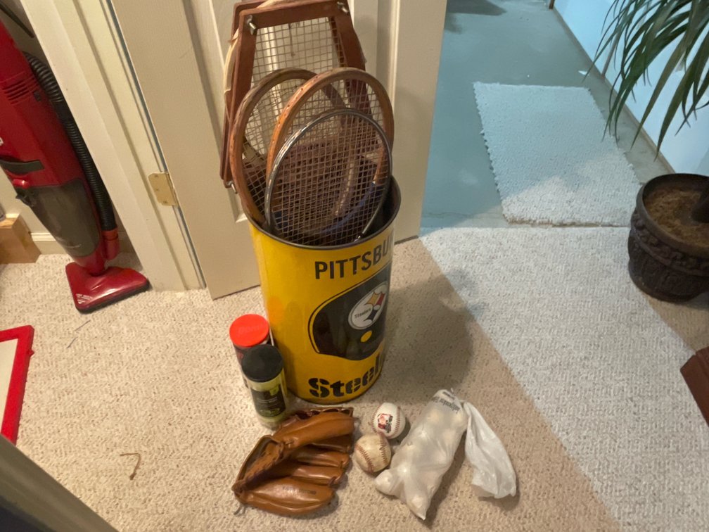 Tennis Rackets, Baseball Glove, and Metal Wastebasket