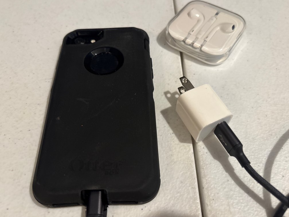 Smartphone with Protective Case, Charger, and Earbuds