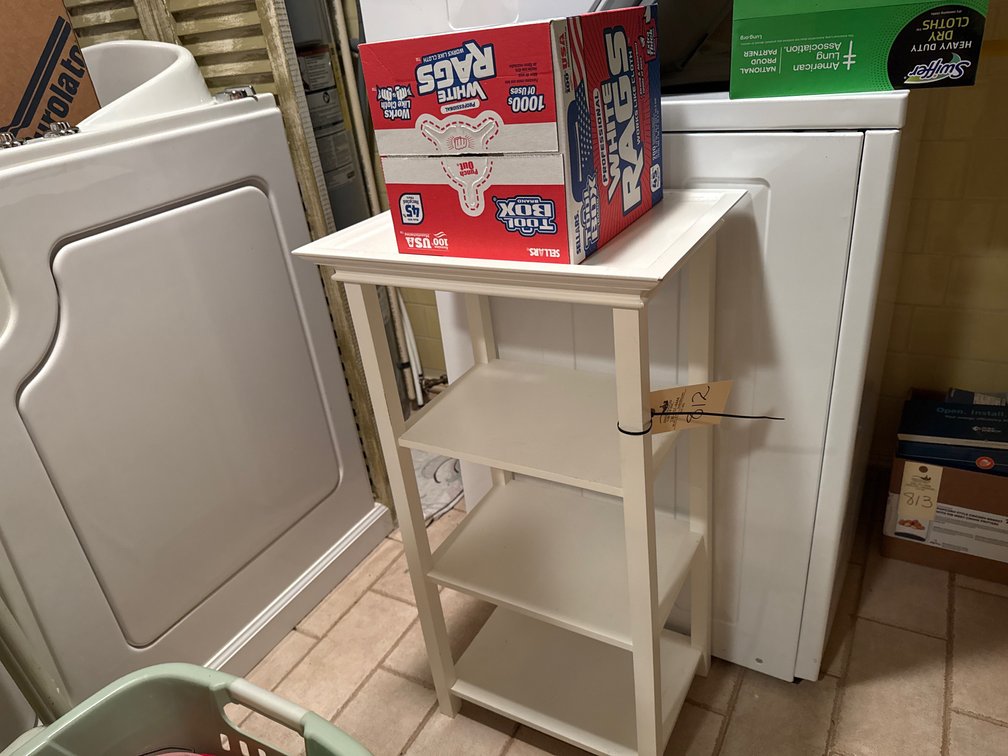 White Four-Tier Shelving Stand and Disposable Towels