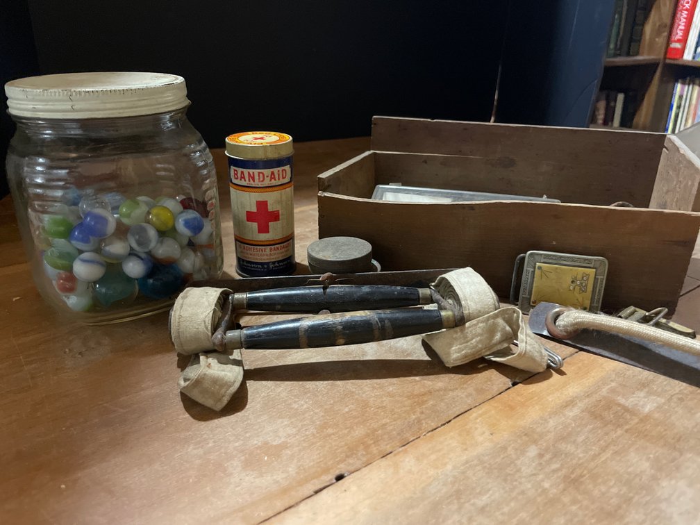 Glass Jar of Marbles, Band-Aid Tin, Belt Buckles, and More