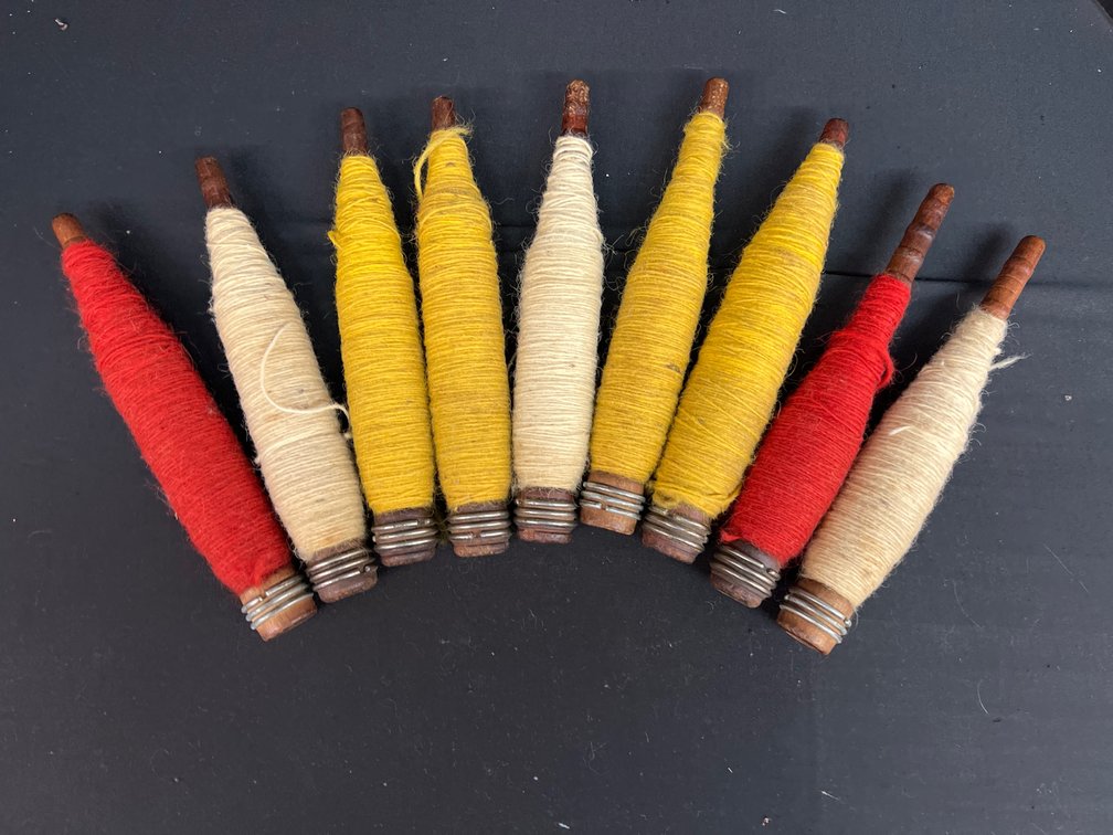 Wooden Textile Mill Bobbins Wound with Yarn