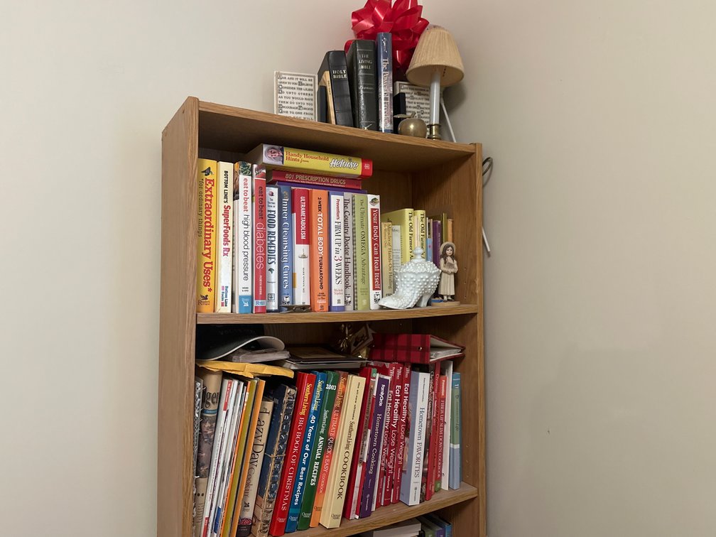 Oak Finish Bookcase with Books, Decor, and Stationery