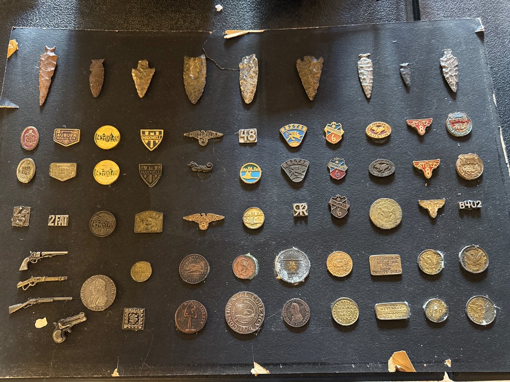 Automotive Emblems, Stone Arrowheads, and Replica Coins