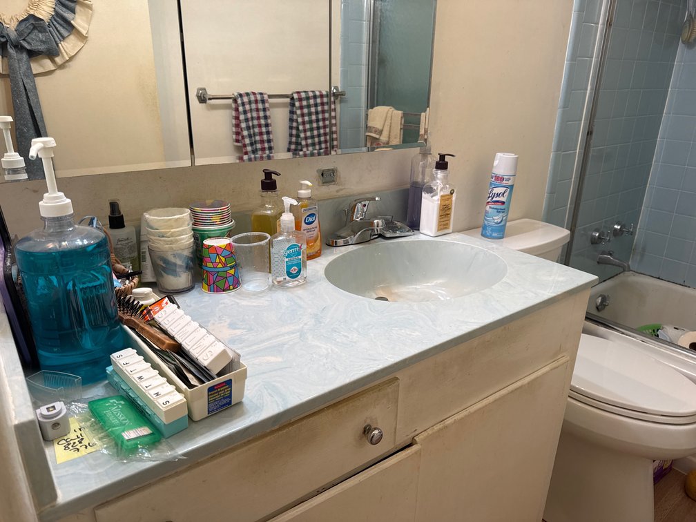 Bathroom Toiletries, Towels, Scale, and Cleaning Supplies